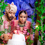 indian couple cutting wedding cake
